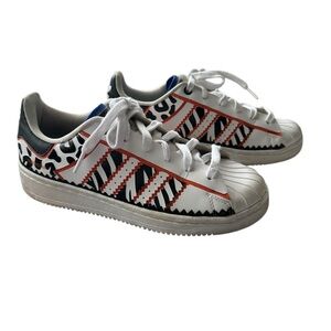 Adidas Rich Mnisi Superstar OT Tech shoe in Cloud White/Core Black/True Orange.